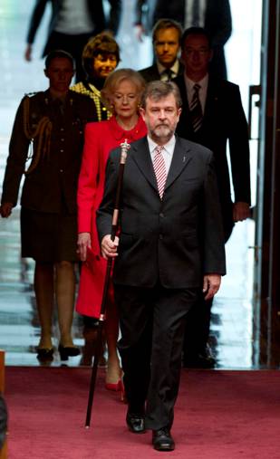 The Usher of the Black Rod escorts the Governor-General and the official party into the Senate chamber